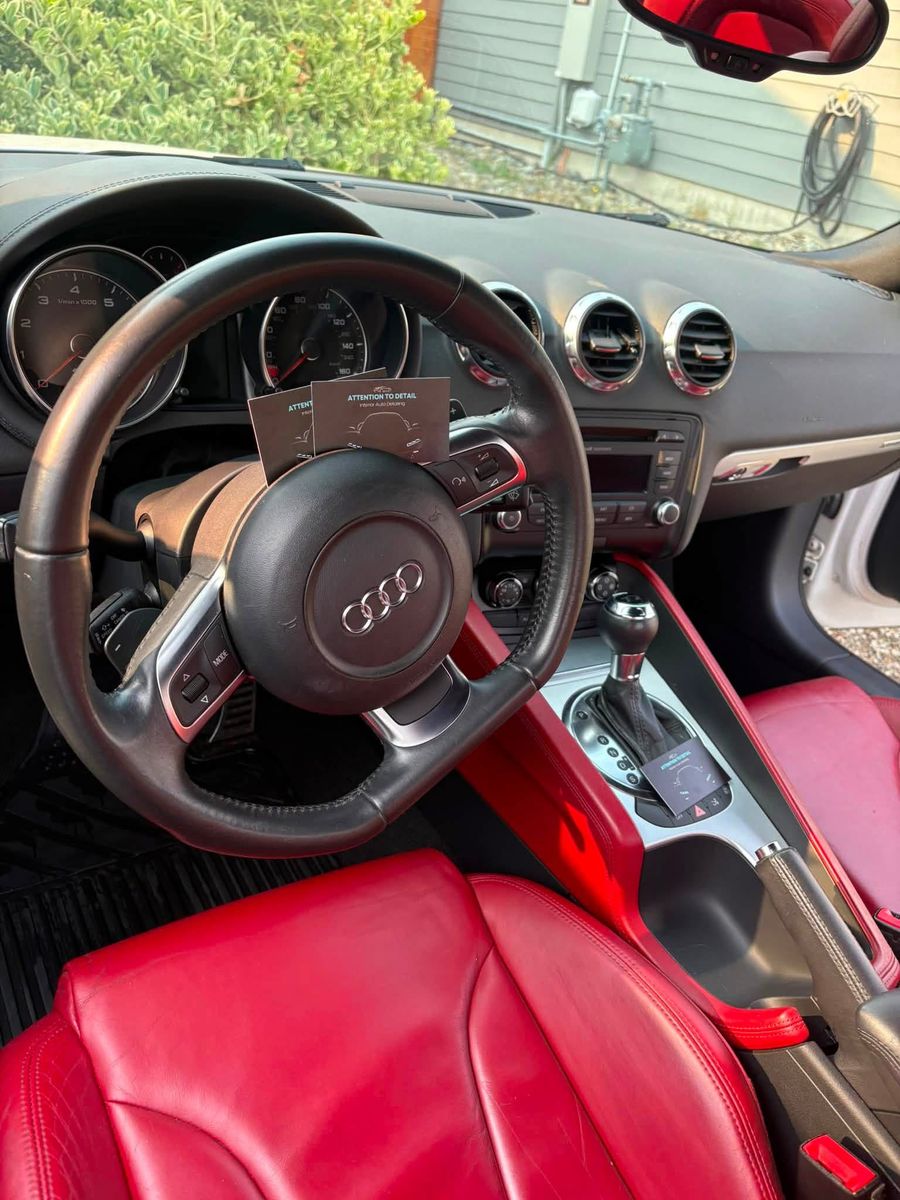 Detailed Audi TT dash, steering wheel and red leather seats