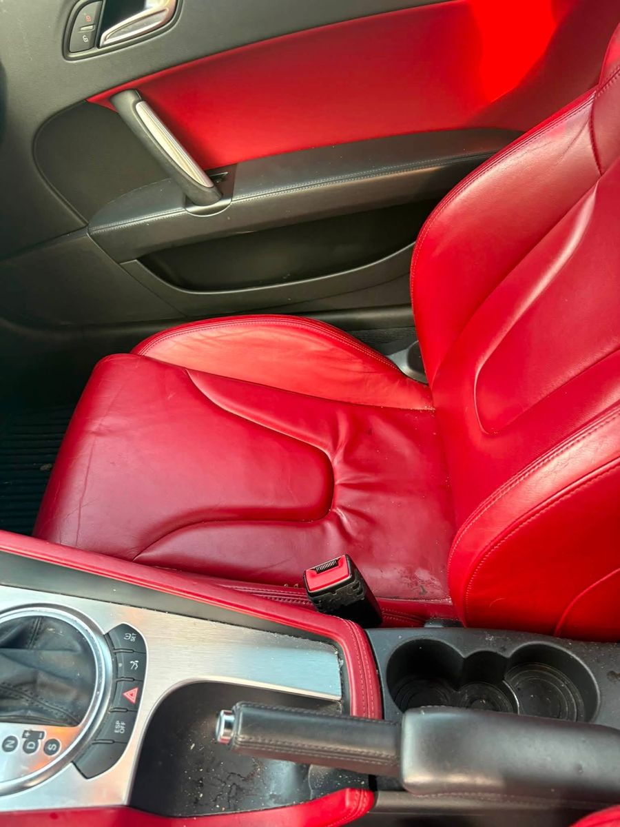 Audi TT before detailing: dusty red leather seats and console