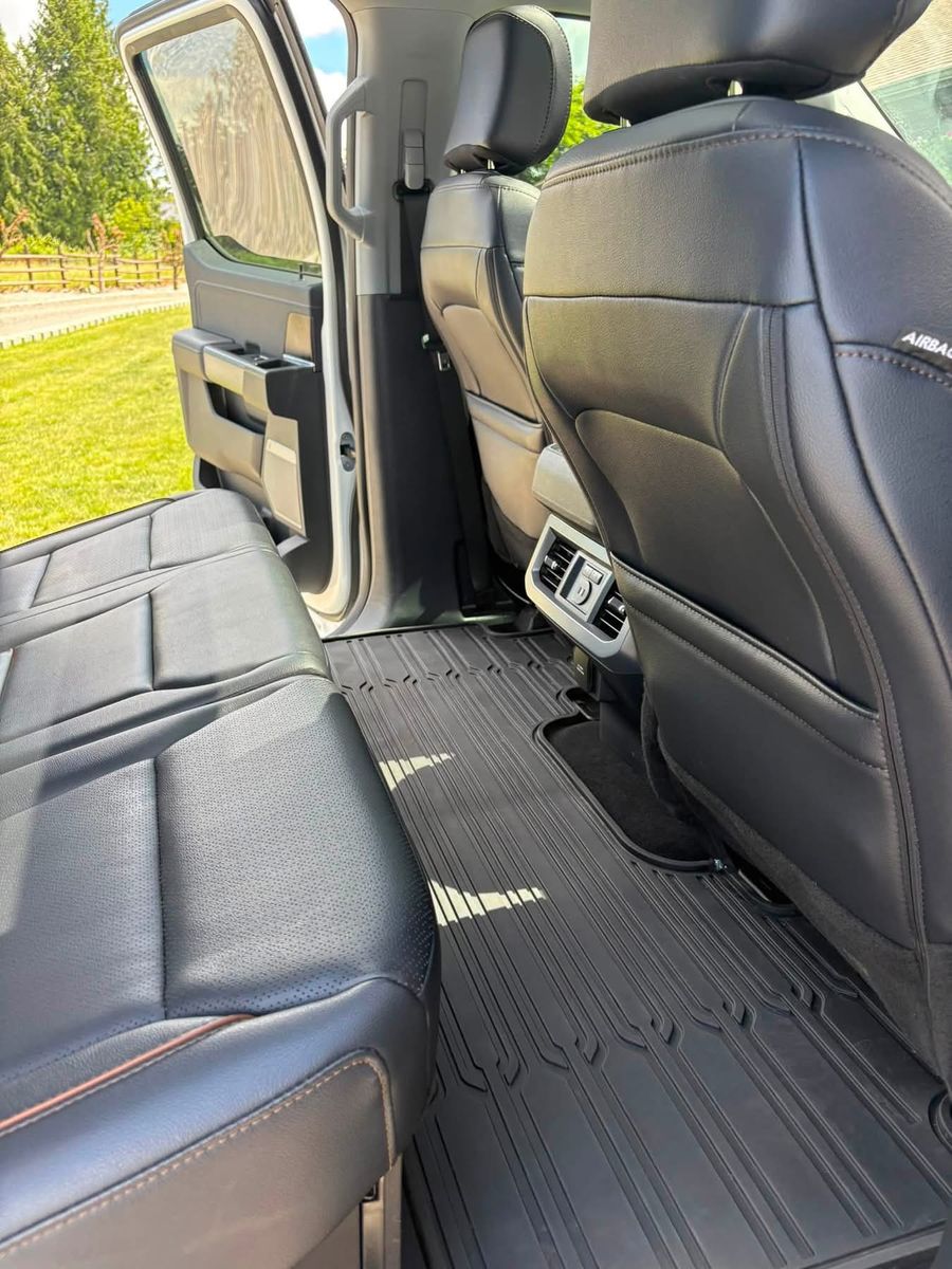 Detailed rear leather seats and all-weather mats in a Ford F-150