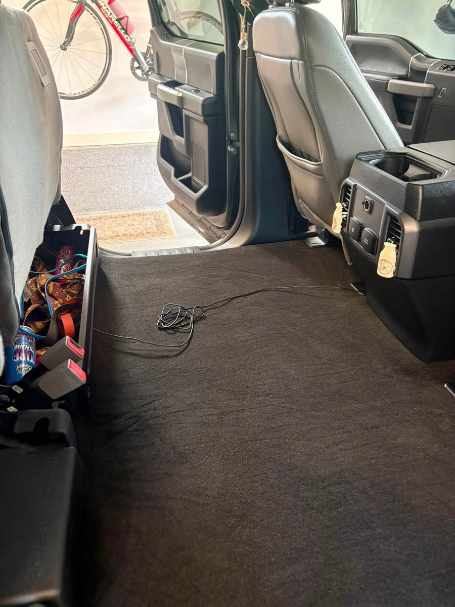 Vacuumed rear floor and seats of a Ford F-150 crew cab